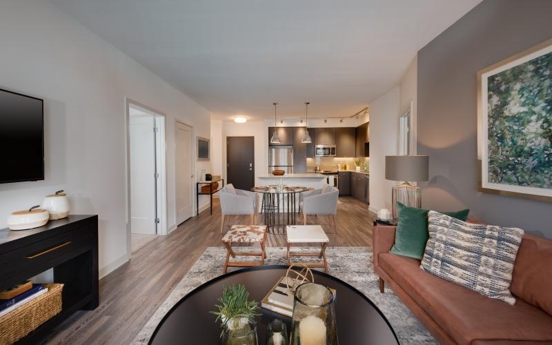 a living room with a large dining table and couches