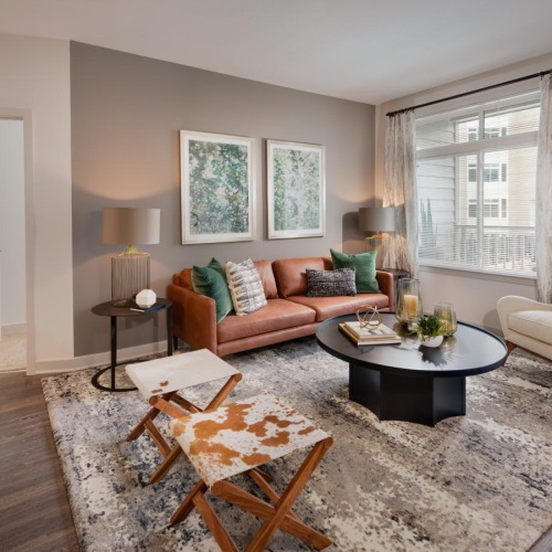 a living room with a rug and a coffee table